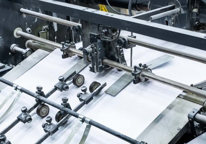 Process of printing at factory: close-up of linotype machine using technology for typesetting text